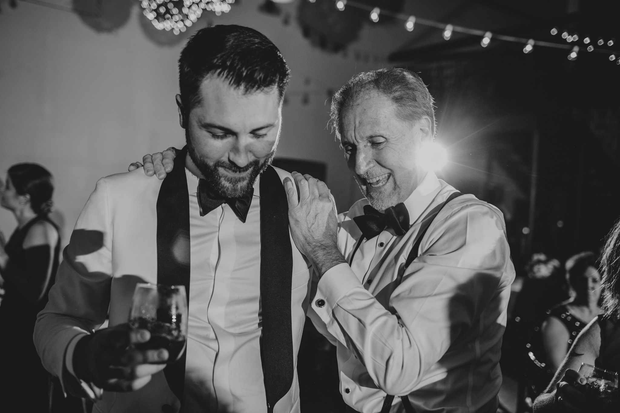 father and son have a moment at a 214 Martin St wedding reception