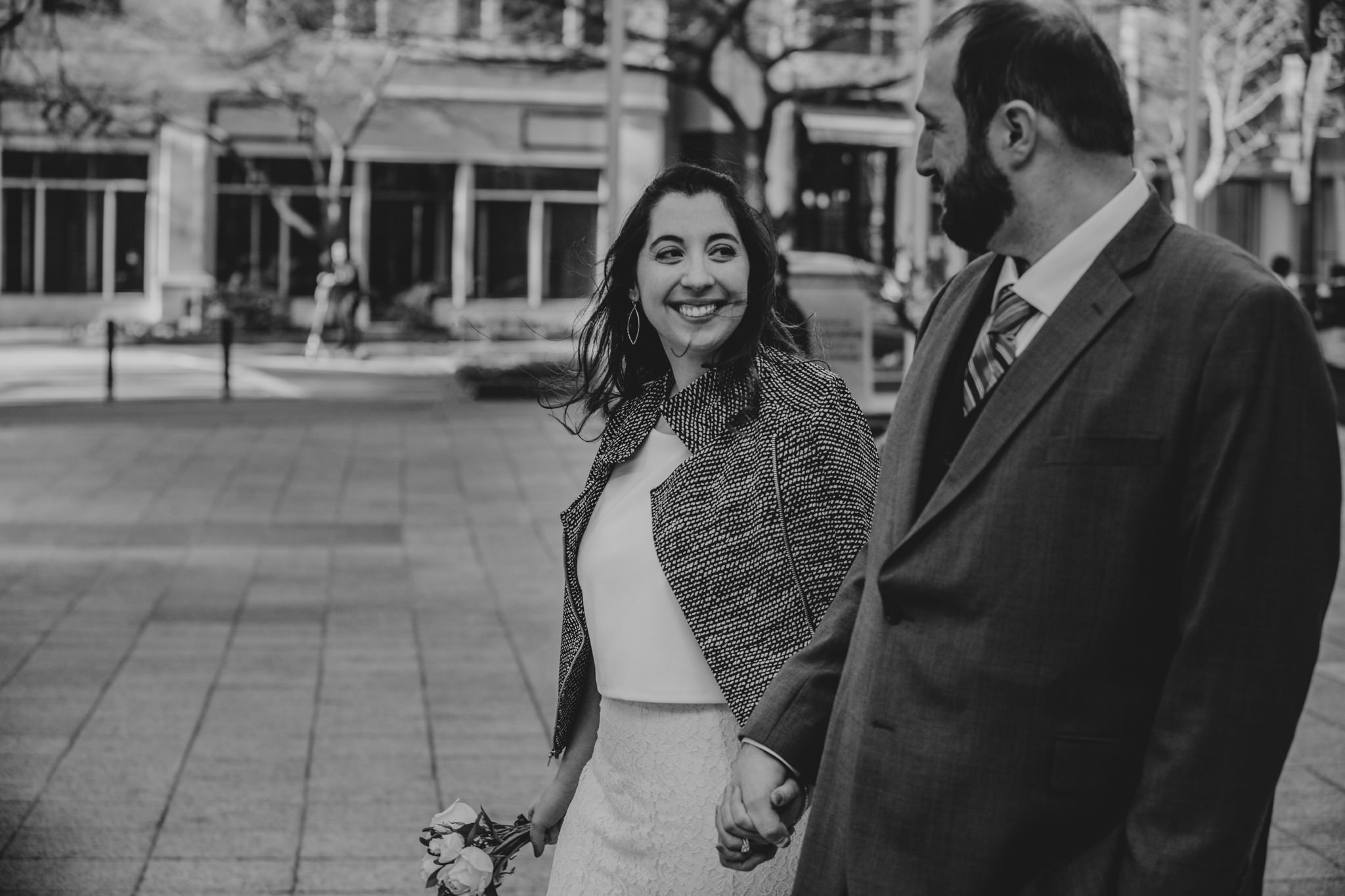 newly eloped couple walk the streets of uptown Charlotte together