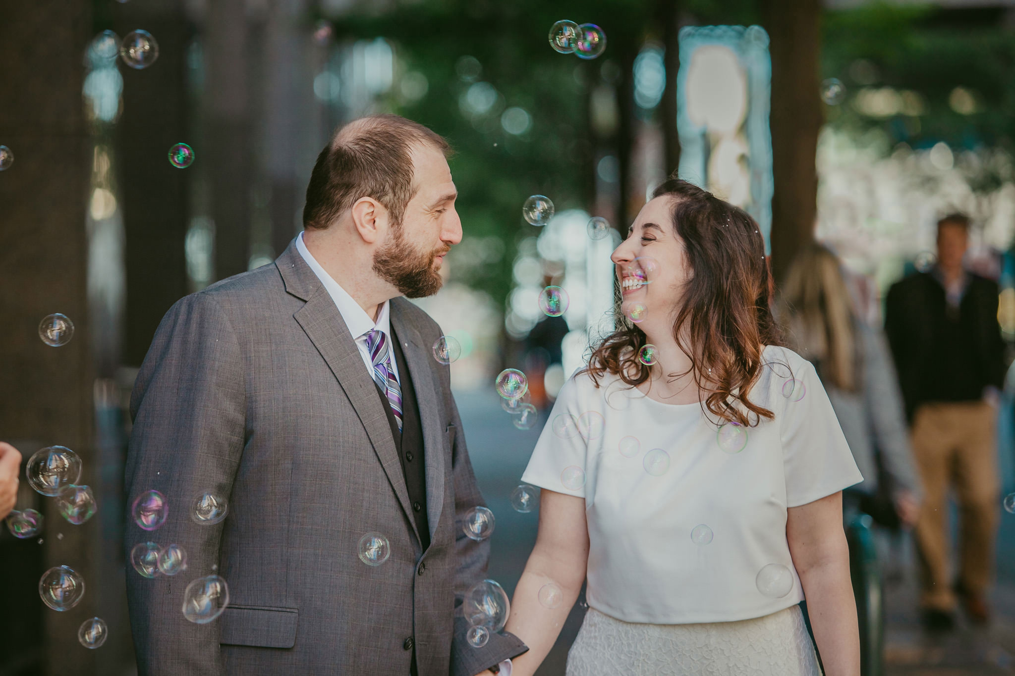 bubbles surround this newlywed couple on the streets of uptown Charlotte