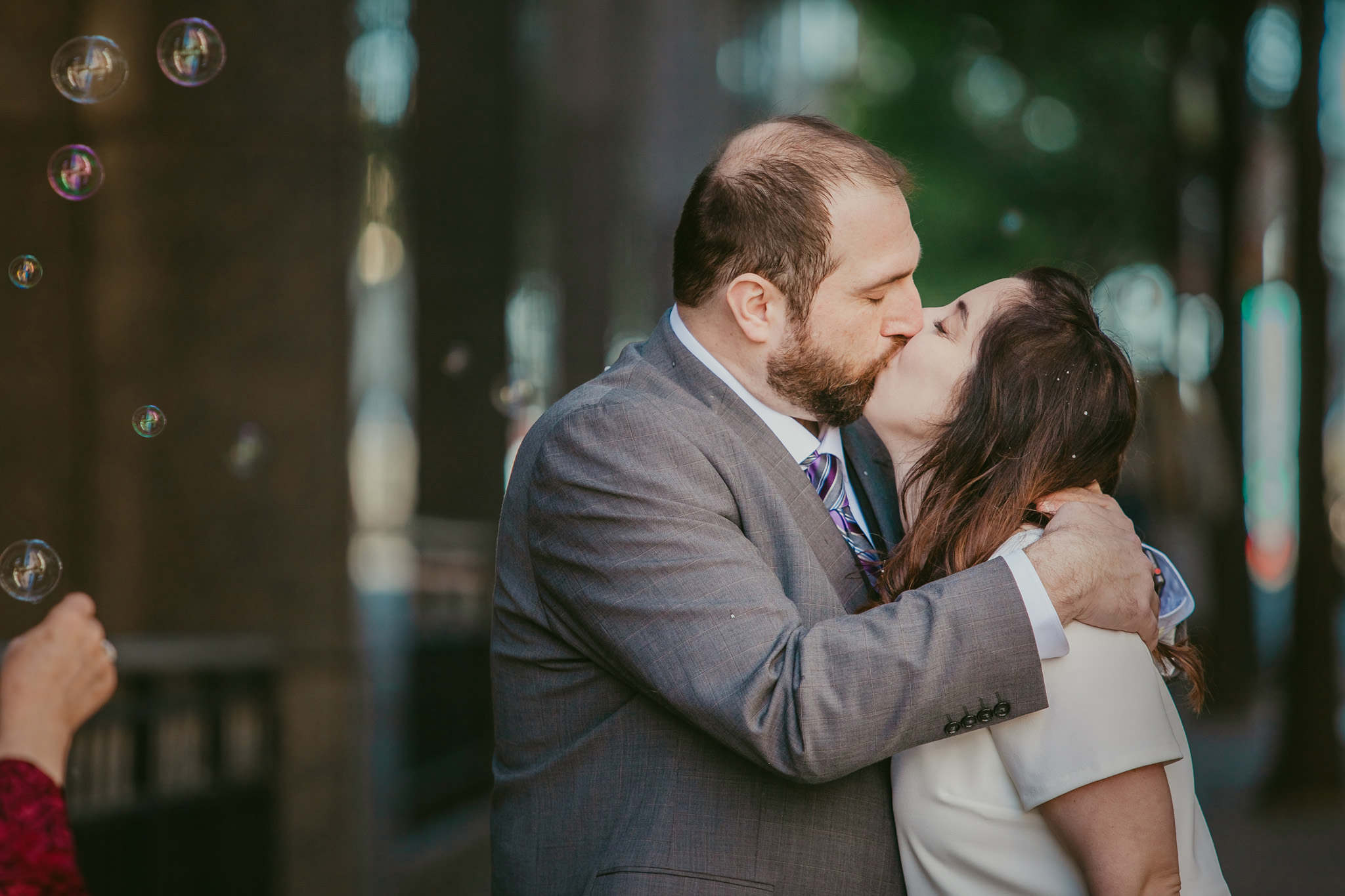 Newly eloped couple kisses on the streets of uptown Charlotte