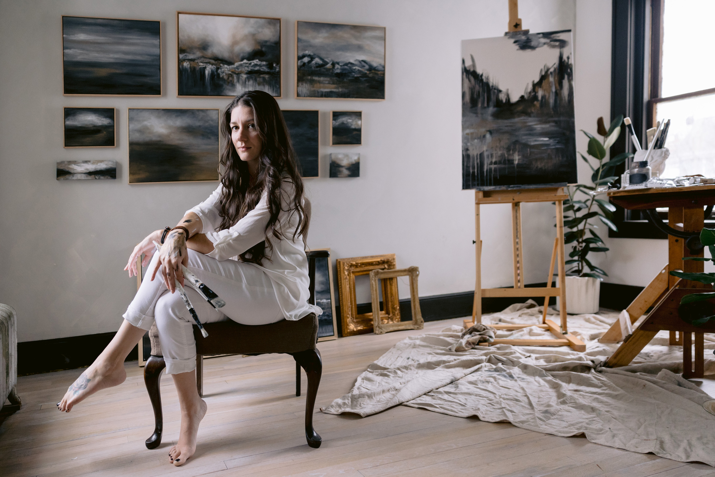 Emily O'Rielly, artist, sitting at easel for personal brand photoshoot with Mabyn Ludke Photography.